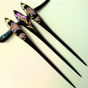 Front of ebony hairpin with purple floral lacquer and gold-painted details