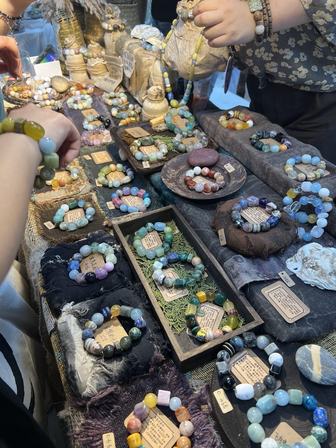 Colorful beaded bracelets displayed at a fellow artisan market stall