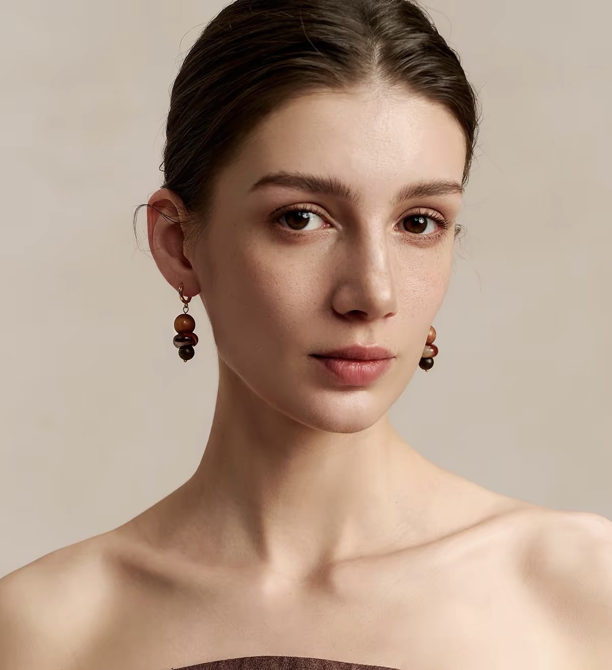 Model wearing agate and wood drop earrings