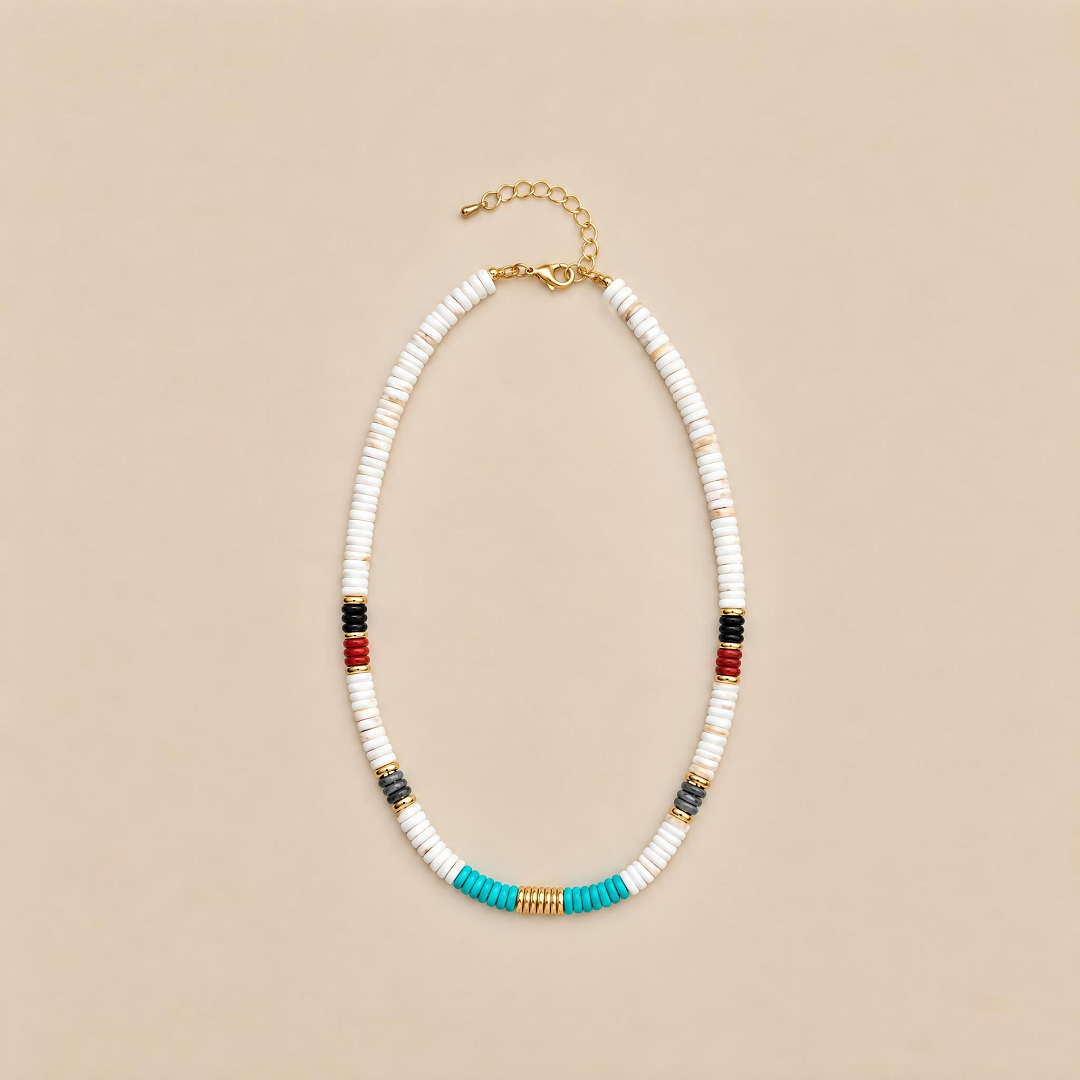 White beaded necklace with turquoise center and red and black accents