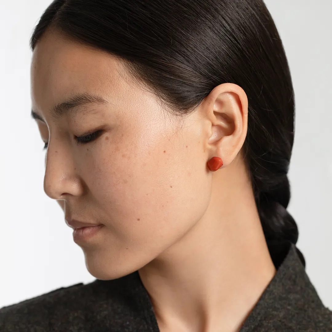Woman wearing natural Nanhong agate stud earrings