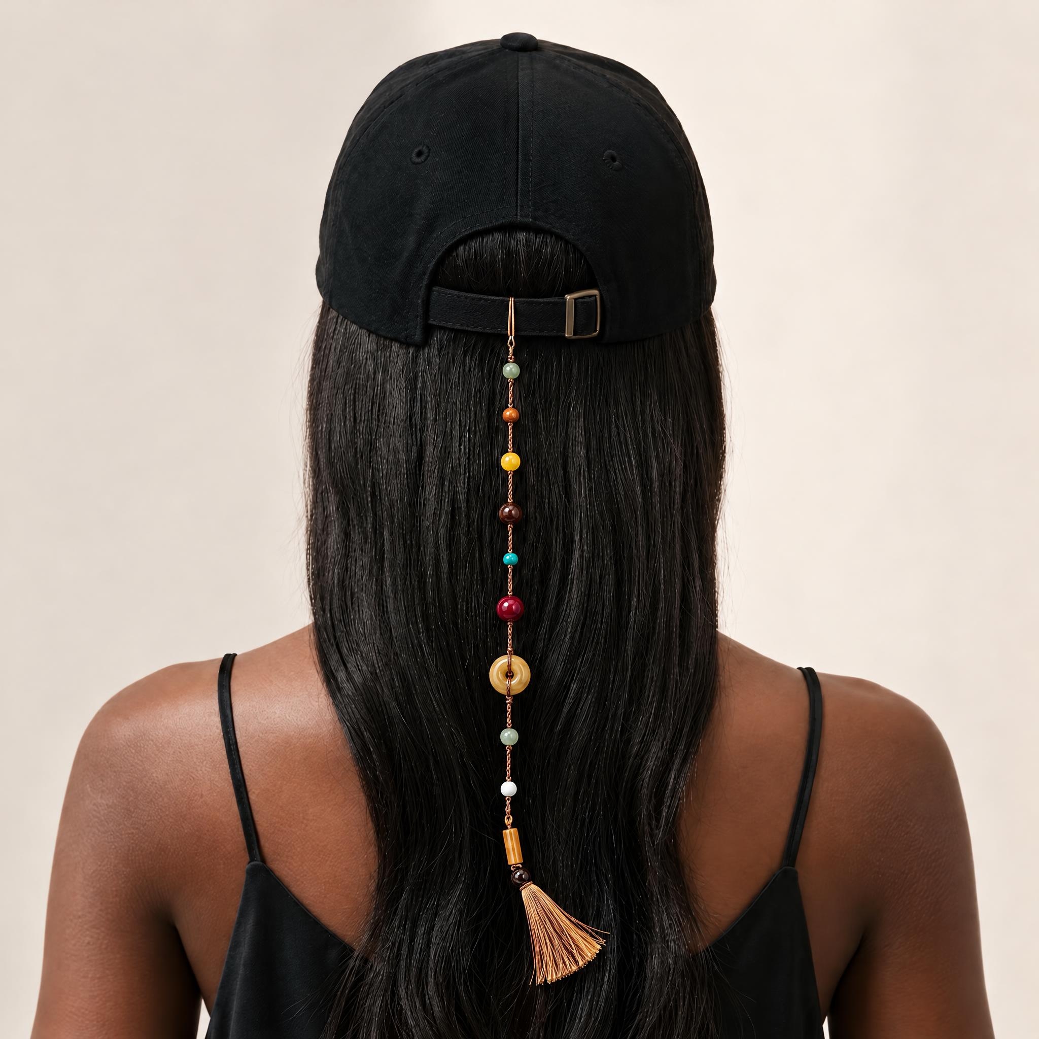 Free Spirit gemstone tassel charm hanging from the back of a baseball cap.