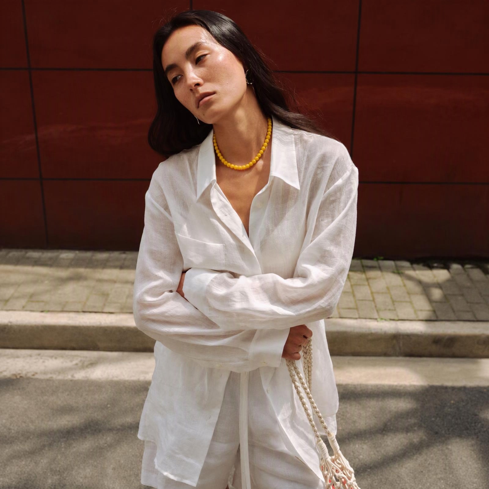Woman wearing a natural beeswax amber bead necklace