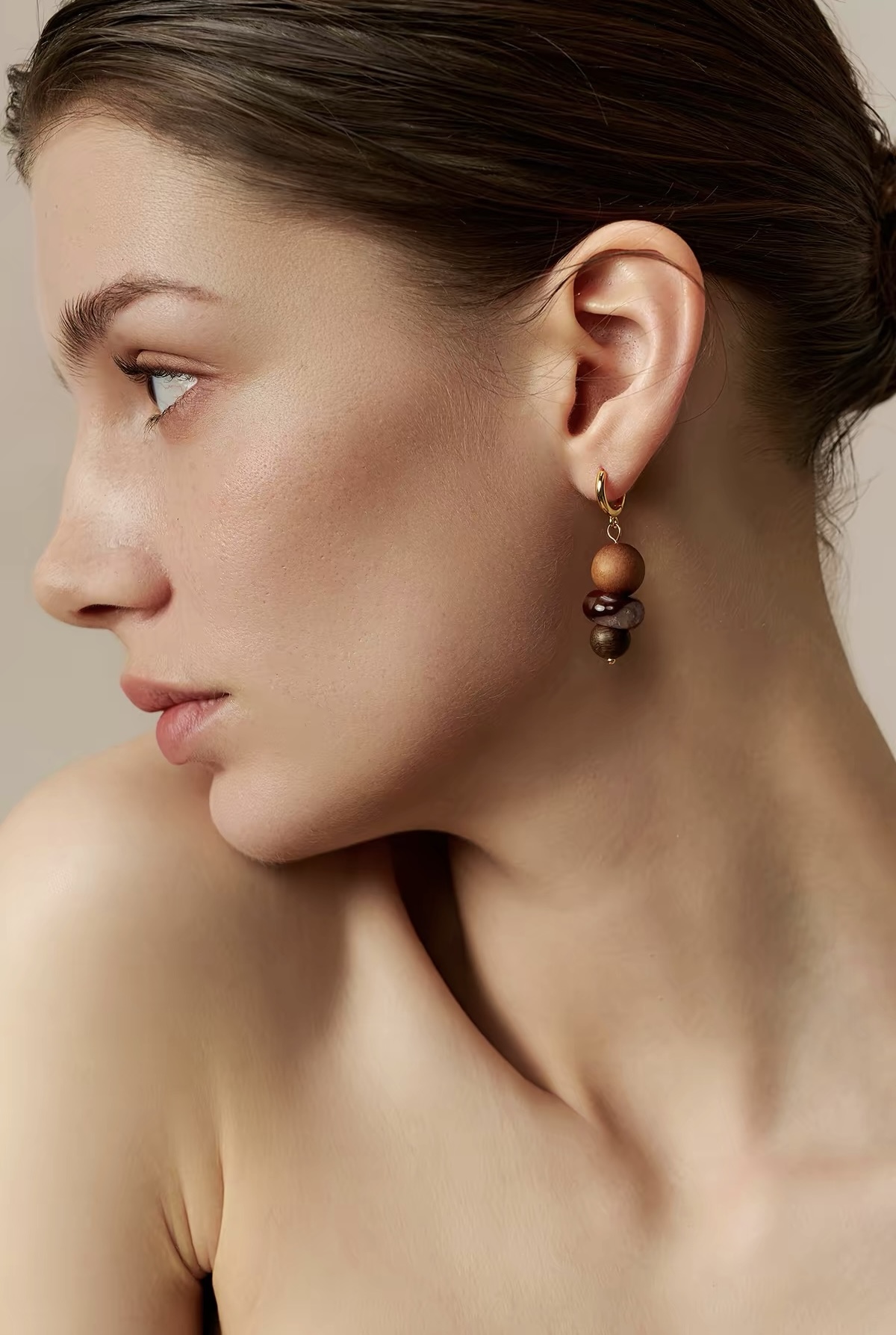 Model wearing agate and wood drop earrings