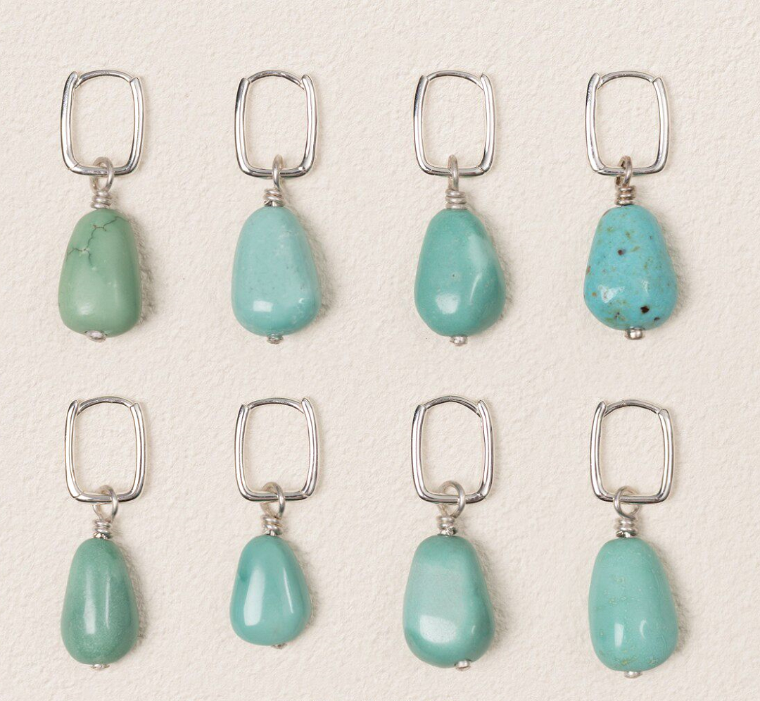 Eight individual turquoise earrings showing natural variations in color and shape