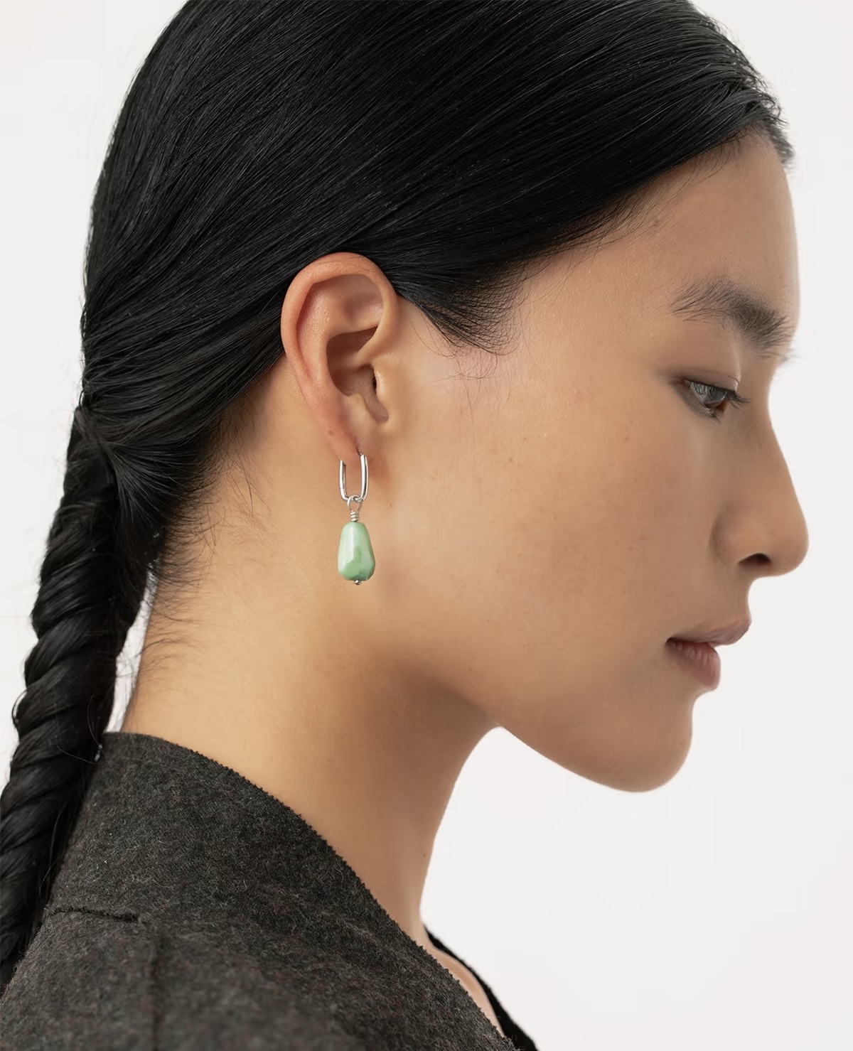 Woman wearing a natural turquoise drop earring