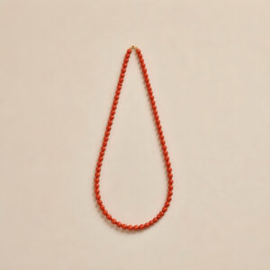 6mm natural red agate bead necklace laid flat on neutral background showing 45cm full strand and clasp detail.