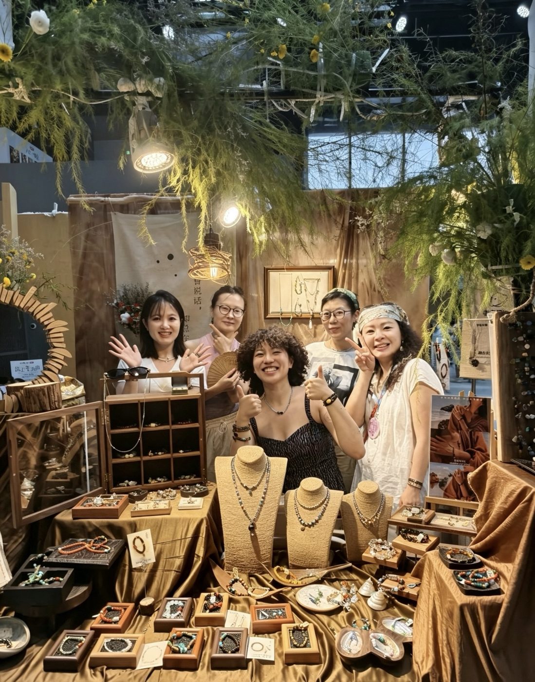 A warmly lit RONGHUA market booth with a group gathered around the display