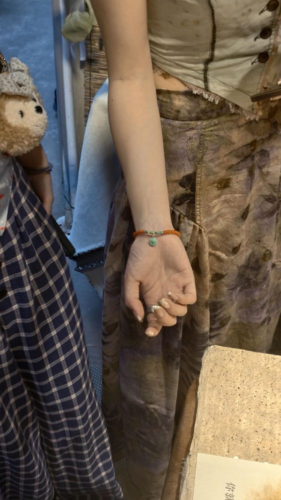 A close-up of a bracelet being worn at the market