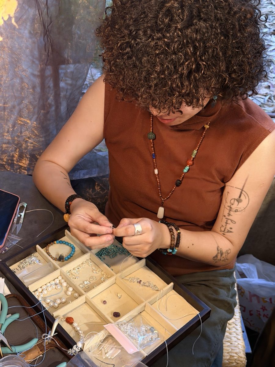 CJ working with beads and components while making jewelry